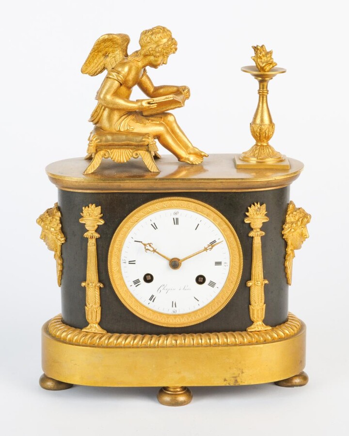 A Empire clock with a reading putti