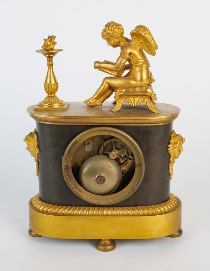 A Empire clock with a reading putti